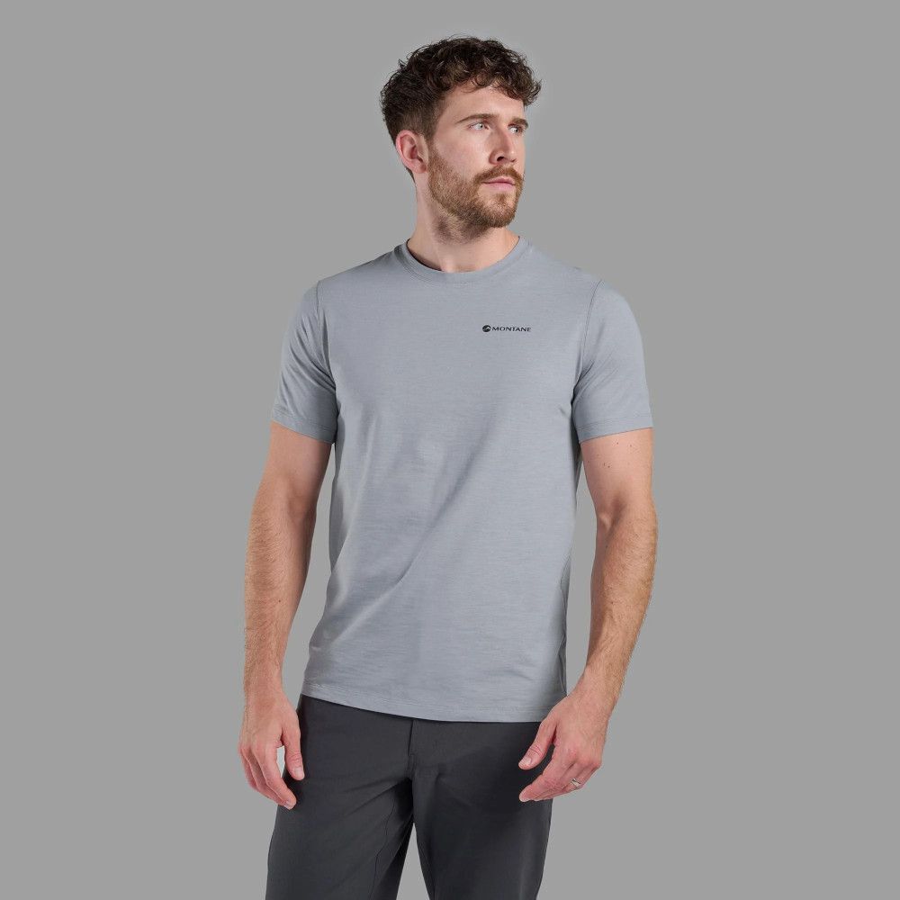 Male model wearing a light gray short-sleeve t-shirt with a small Montane logo on the chest, standing against a neutral backdrop.