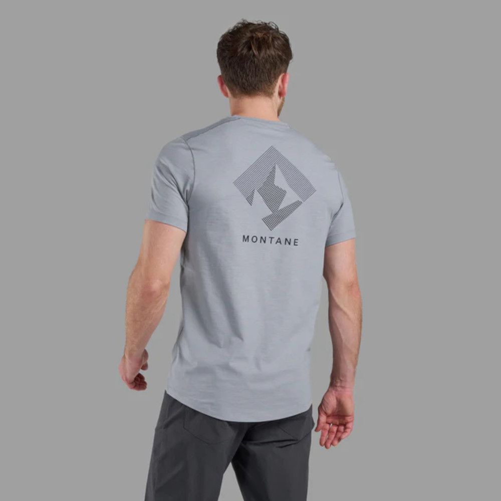 Back view of man wearing a light gray Montane tee with a geometric logo on the upper back.