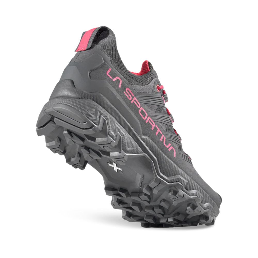 Side view of a gray La Sportiva trail running shoe with pink accents and a chunky, lugged sole.