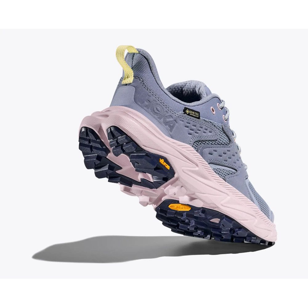 Blue/lavender trail running shoe with pink midsole and yellow pull tab, showing rugged black outsole side view, product image
