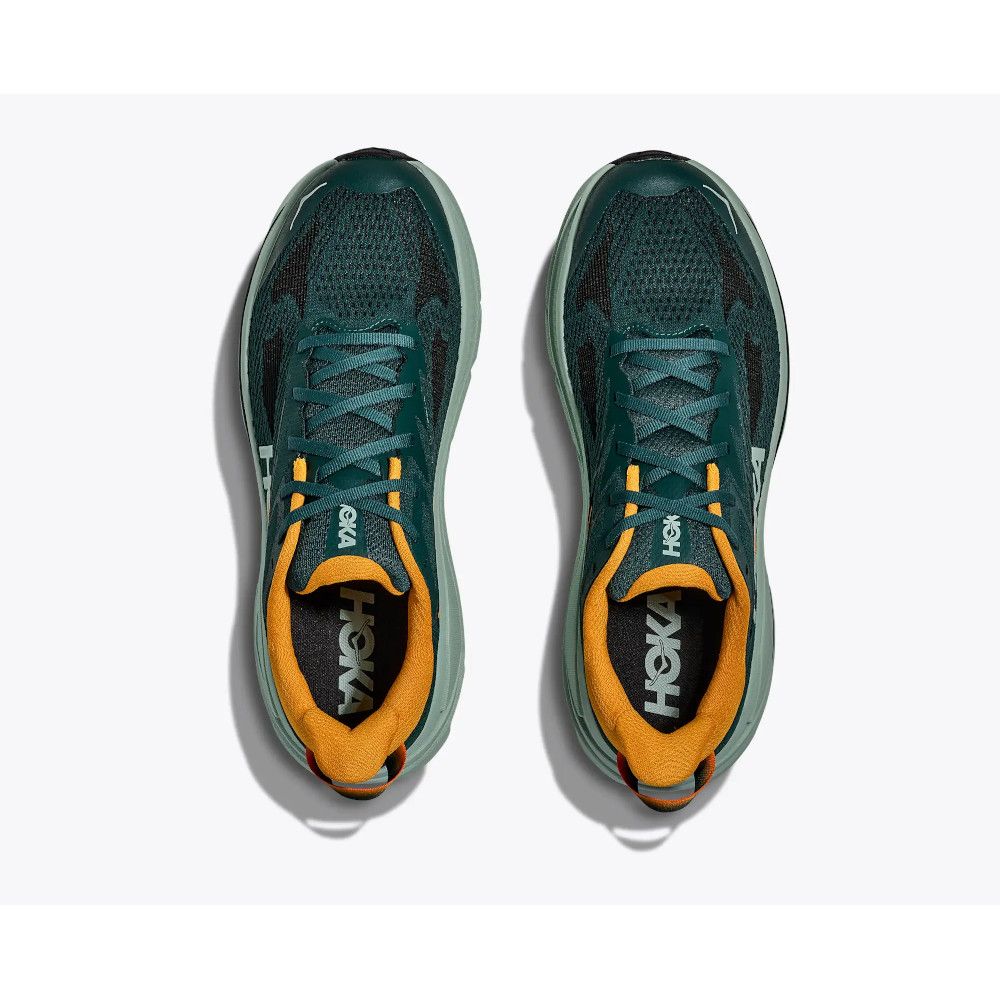 Top-down view of teal Hoka running shoes with orange interior lining and laces, shown from above on a light background; a pairside-by-side.