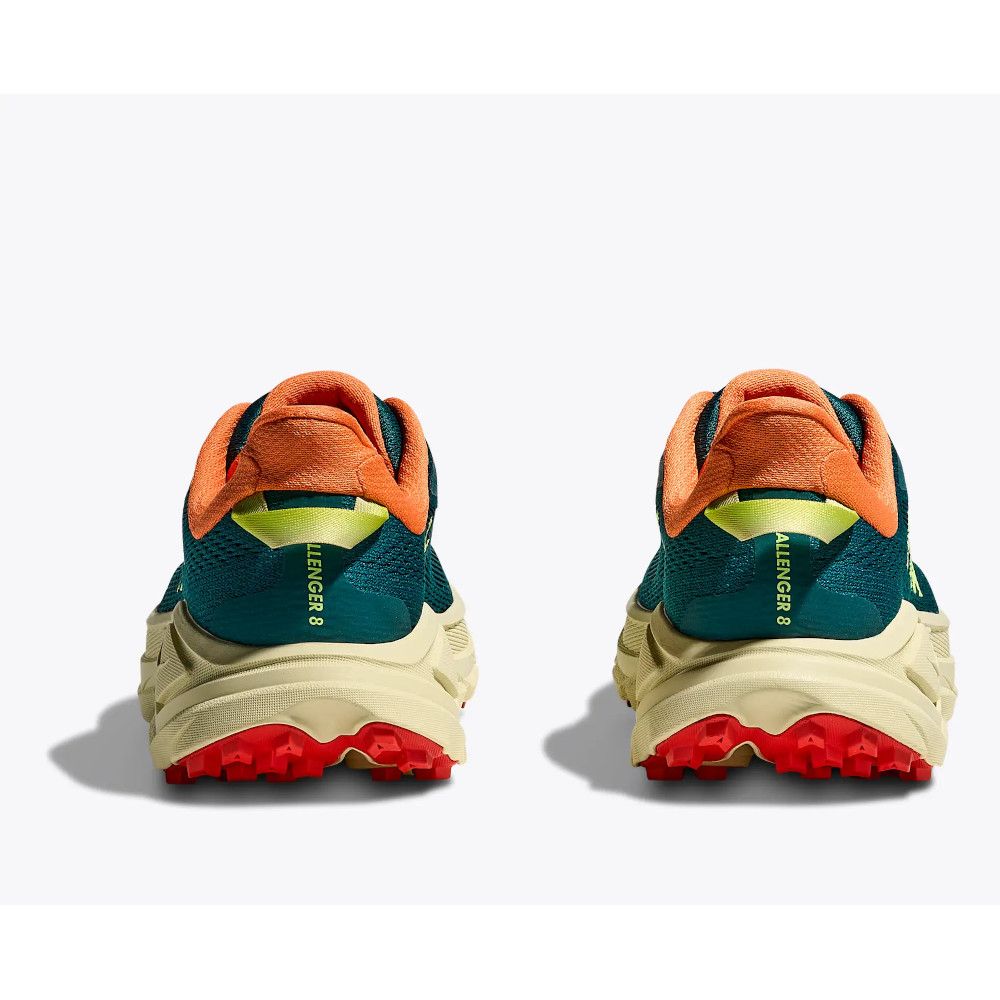Pair of teal and orange trail running shoes shown from the back, with beige midsoles and bright red outsoles.
