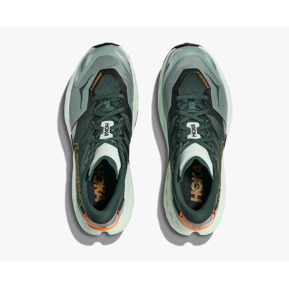 Pair of green HOKA running shoes viewed from above, laces tied, on a light background.”] ,