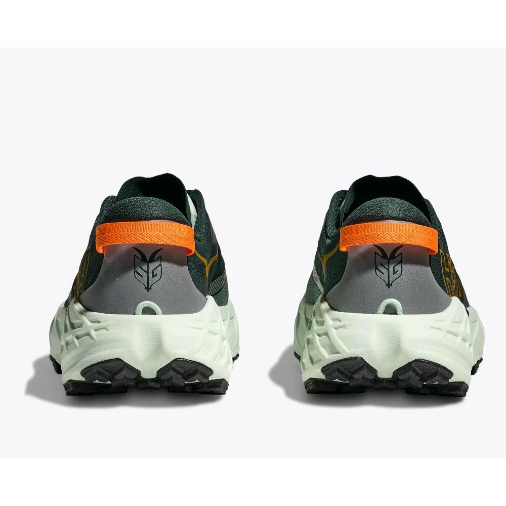 Pair of dark green running shoes viewed from the back, with orange heel tabs and chunky white midsoles.