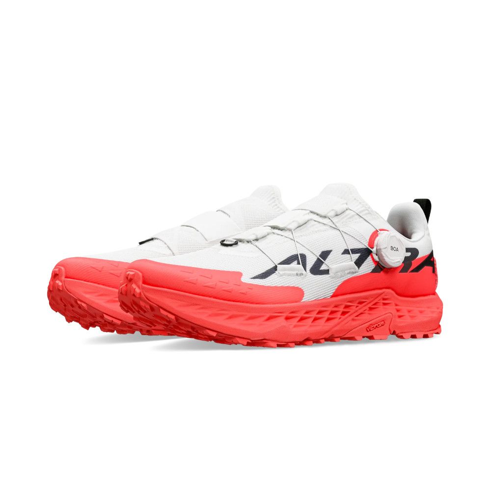 White trail running shoes with bright red outsole and a BOA dial on the side for tightening.