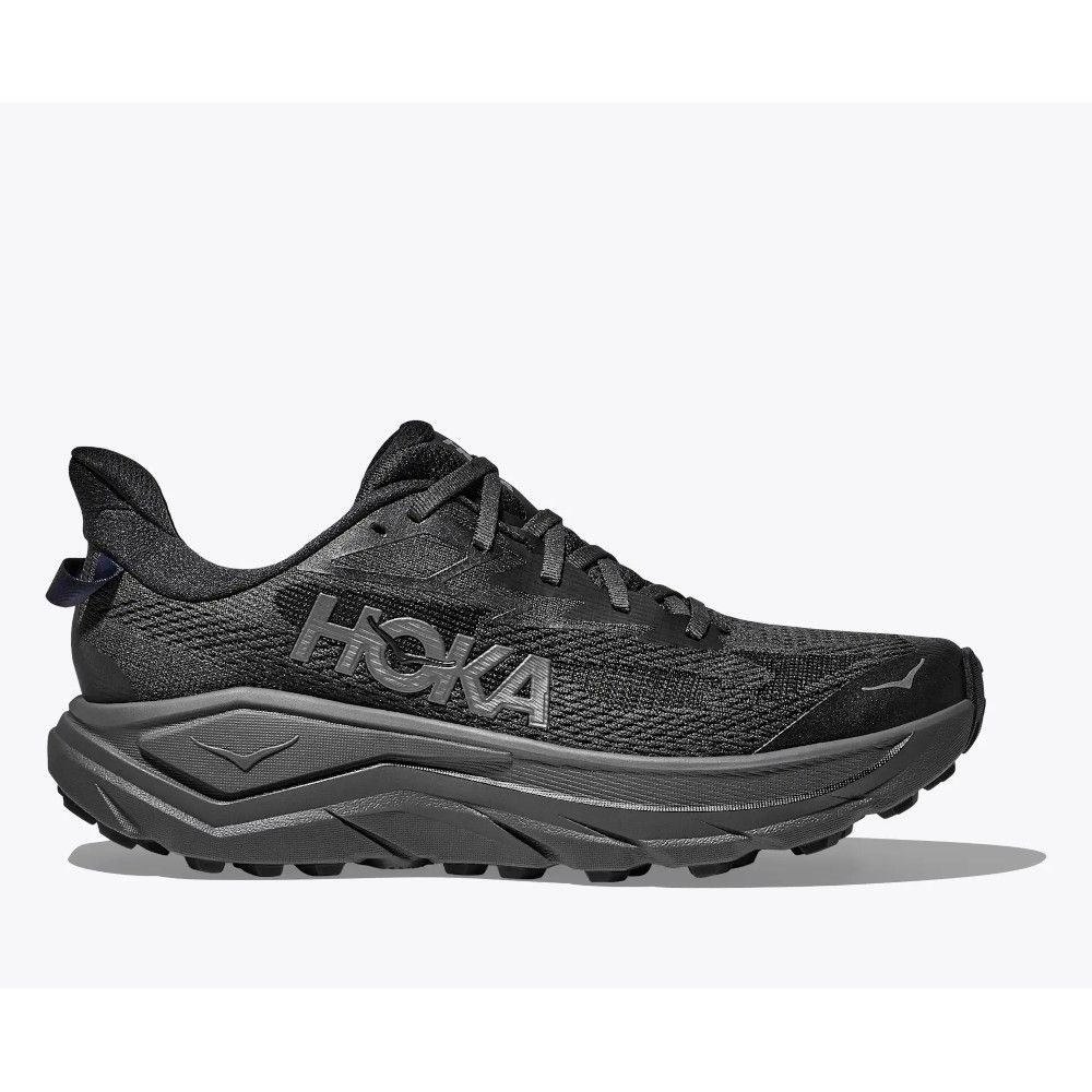 1_43c614ff-305c-487c-b528-744a22aa94cf Black HOKA trail running shoe in profile with a chunky gray midsole and rugged outsole, showing the textured knit upper.