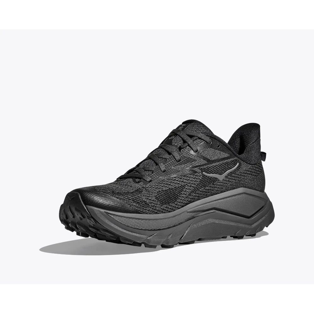 1_43c614ff-305c-487c-b528-744a22aa94cf Black and gray trail running shoe with a chunky rugged sole and textured knit upper, shown from a side angle on a light background with shadow underneath.