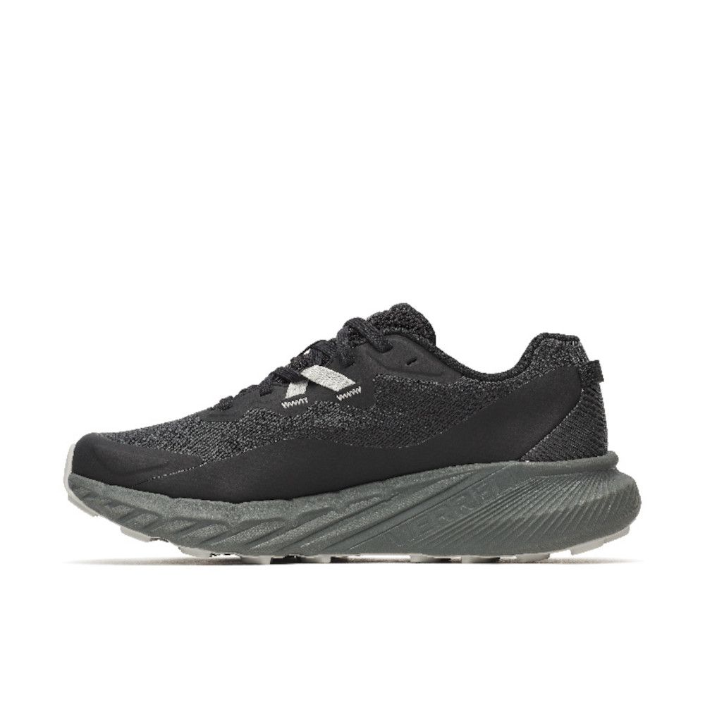 Black athletic sneaker with a textured knit upper and chunky gray sole, side view of shoe