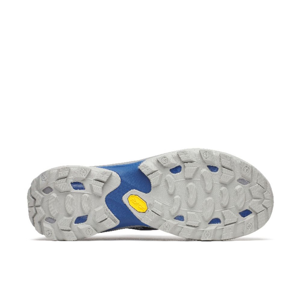 Bottom view of a blue athletic shoe showing a rugged gray outsole with deep lugs and a yellow Vibram logo.