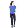 1_43c614ff-305c-487c-b528-744a22aa94cf Woman standing in a blue short-sleeve t-shirt and black hiking pants with teal-laced boots, looking to her left.