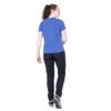 1_43c614ff-305c-487c-b528-744a22aa94cf Woman seen from behind wearing a blue short-sleeve shirt and dark athletic pants, mid-step, white sneakers with blue accents.