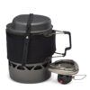 1_43c614ff-305c-487c-b528-744a22aa94cf Compact camping stove with a metal pot strapped above and a black fabric sleeve around the burner for carrying.