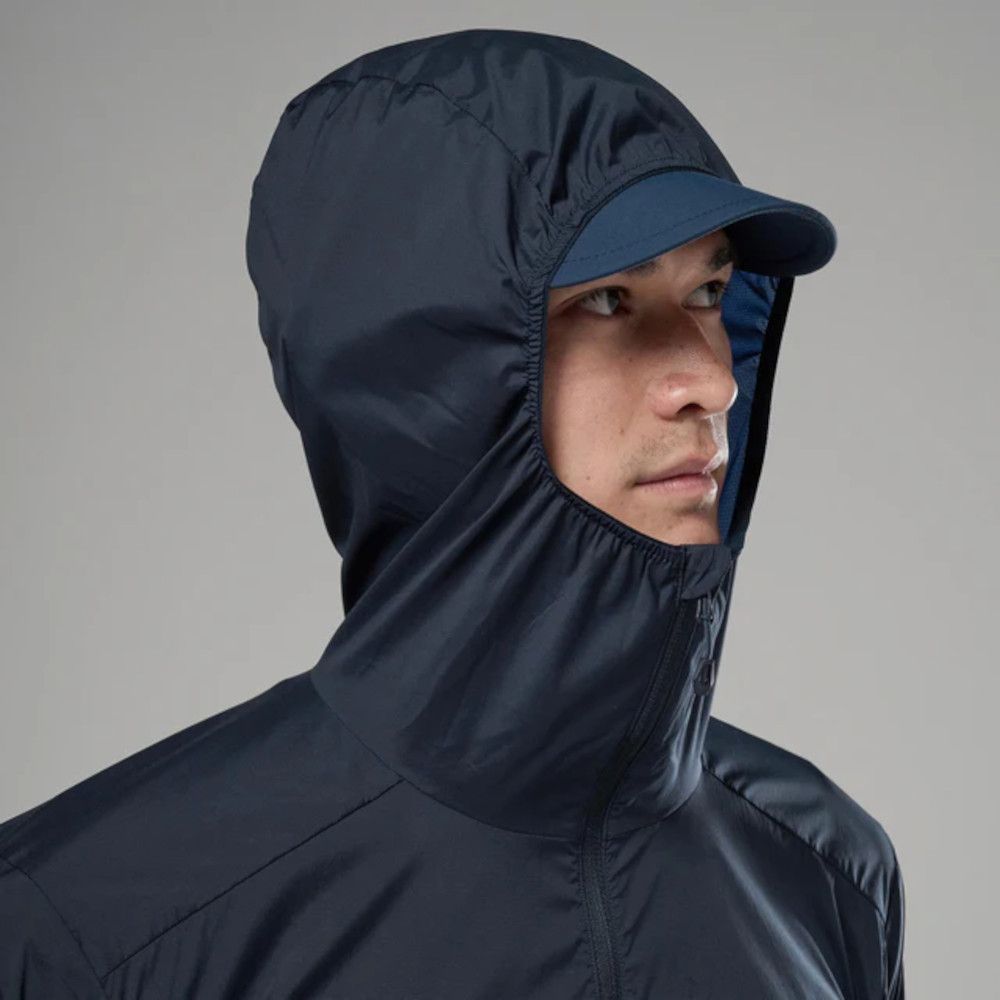 1_43c614ff-305c-487c-b528-744a22aa94cf Person wearing a navy windbreaker with hood and cap, facing right in a profile view.