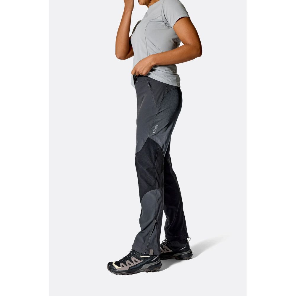 1_43c614ff-305c-487c-b528-744a22aa94cf Person in a light gray athletic t‑shirt and dark hiking pants, shown in profile to display outdoor apparel.