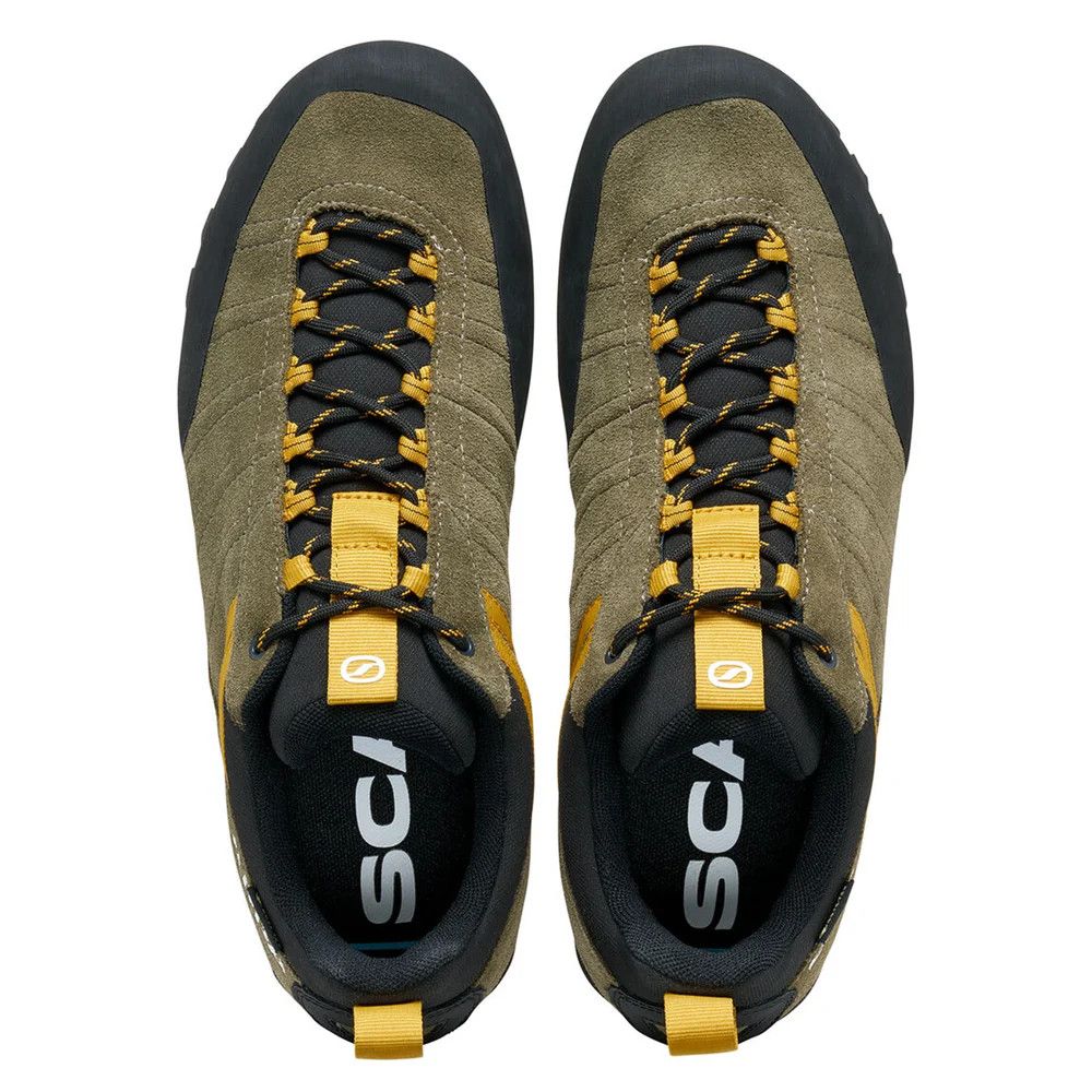Top-down view of olive-green hiking boots with black and yellow laces and pull tabs at the heel and tongue