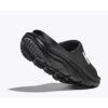1_43c614ff-305c-487c-b528-744a22aa94cf Black slip-on athletic shoe shown at an angle to highlight the rugged tread outsole and side silhouette