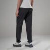 1_43c614ff-305c-487c-b528-744a22aa94cf Back view of a person wearing dark gray athletic joggers with cuffed ankles and white top in a neutral studio setting.