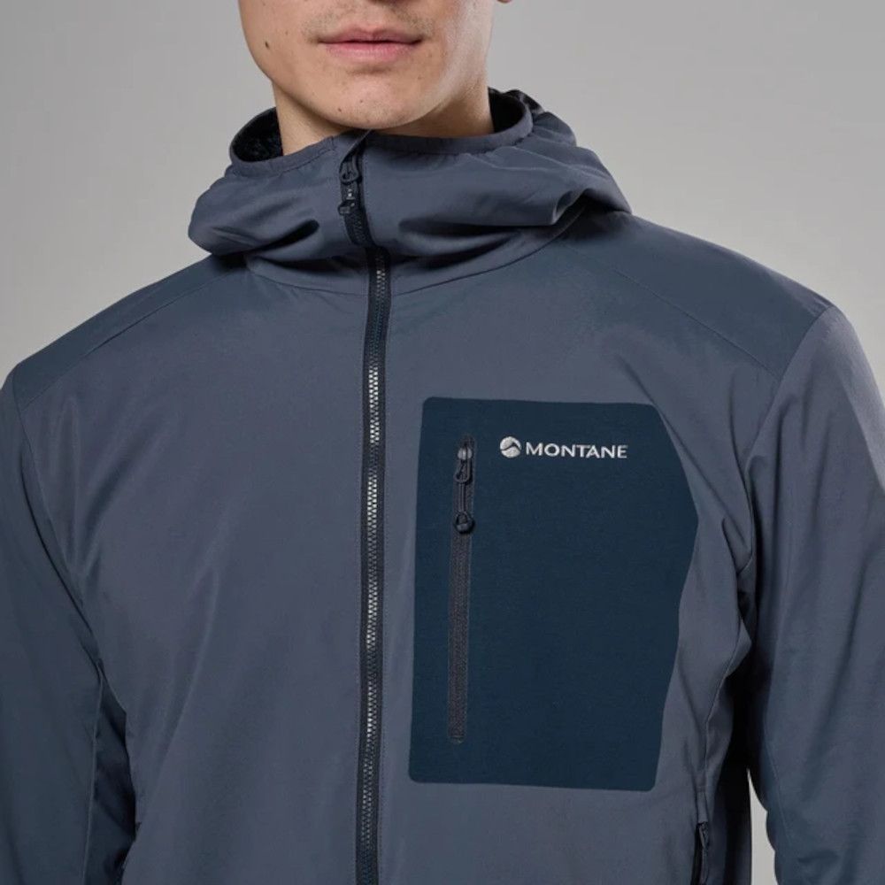 Close-up of a person wearing a blue-gray Montane jacket with a dark blue zippered chest pocket on the left, logo visible.