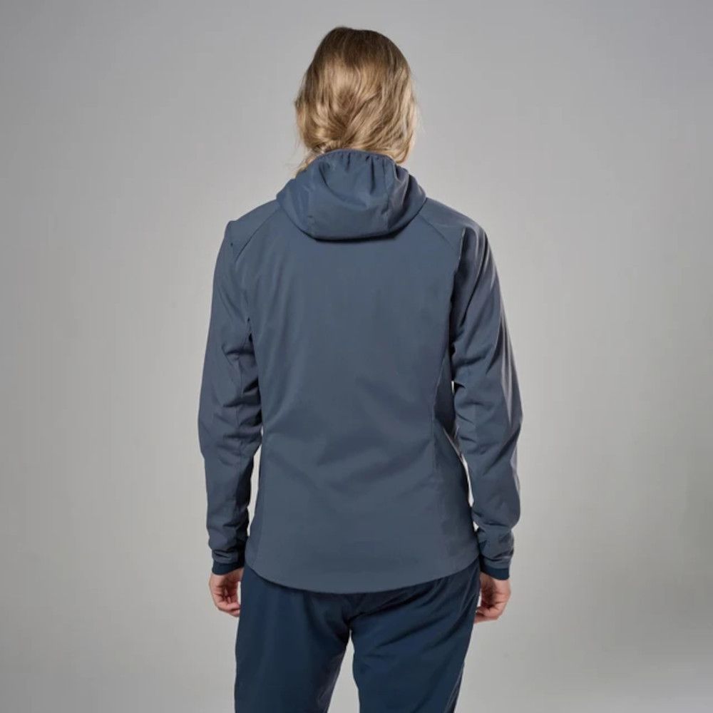 1_43c614ff-305c-487c-b528-744a22aa94cf Back view of a person wearing a blue hooded jacket and dark blue pants, standing against a gray studio backdrop.