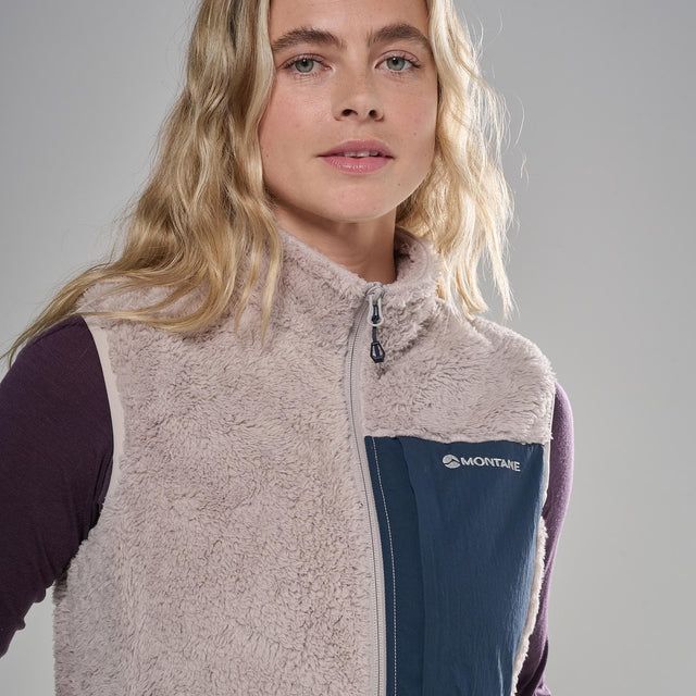 FCXTV_OYS_A_4_square_5e02e667-e788-4a68-828e-384d055045ba_640x Portrait of a woman wearing a cream fleece vest with a navy zip panel and Montane logo on the chest, against a gray background.