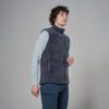 MKLPR_ECL_P_1_square_b214d799-76b2-4a64-a0ae-a2325d30818b_640x Side view of a man wearing a dark gray fleece vest over a light blue long-sleeve shirt, standing indoors.