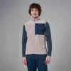 MKLPR_ECL_P_1_square_b214d799-76b2-4a64-a0ae-a2325d30818b_640x Man modeling a beige sherpa fleece vest with a navy chest pocket worn over a blue long-sleeve shirt and matching blue pants.