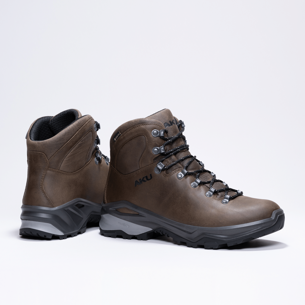 aku_aku_akutributeiiigtx_1791202183138.10_050_TributeIIIGTX_MarroneP Brown hiking boots with black laces and rugged gray soles, viewed from the side. AKU branding visible on the shoe.