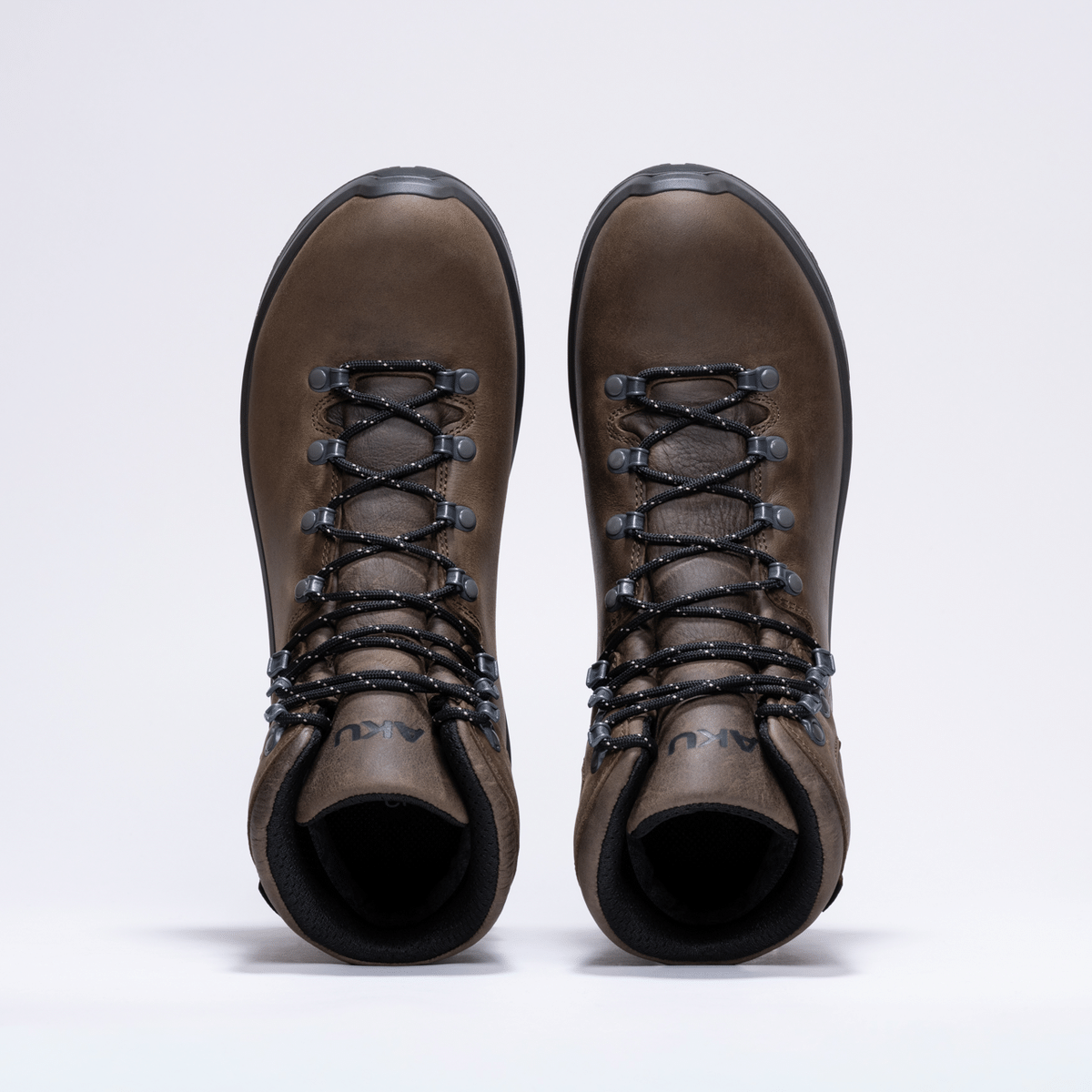 aku_aku_akutributeiiigtx_1791202188138.10_050_TributeIIIGTX_Marrone3 Pair of brown hiking boots viewed from above, laced with black and gray cords against a light background